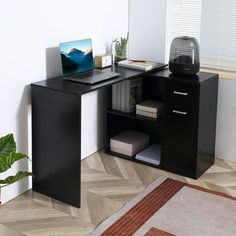 a computer desk with a laptop on it and a rug in front of the desk