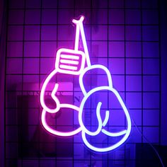 a neon sign with a boxing glove on it in front of a purple tiled wall