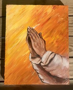 a painting of a person holding their hands together in prayer on an orange and yellow background