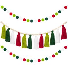 tasselled garland with pom poms, beads and balls on white background