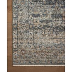 an area rug with various colors and patterns on the floor, including blue, brown, beige