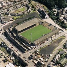 an aerial view of a soccer field in the middle of a city with lots of buildings