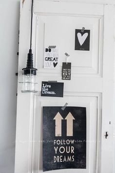 a white door with some magnets on it and a sign that says follow your dreams