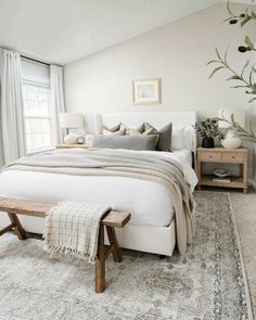 a bedroom with a large bed and wooden benches