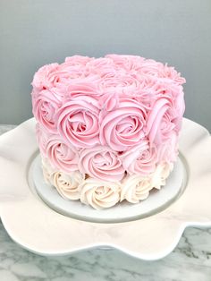 a pink and white cake on a plate