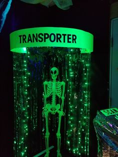 a lighted display with a skeleton in the middle and green lights on it's sides