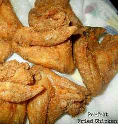 fried chicken pieces are sitting on a paper towel