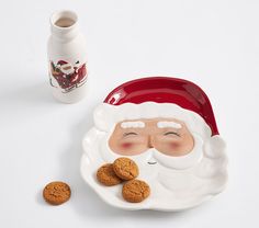 a santa clause plate with cookies next to it