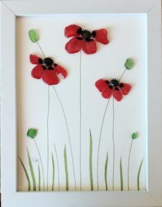 a white frame with some red flowers on it