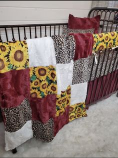 a baby crib with sunflowers and leopard print blankets on it's sides