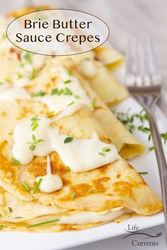 a white plate topped with crepes covered in sauce