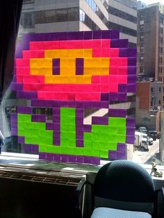 there is a colorful piece of art on the window sill in this office building