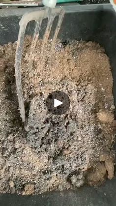 a bucket full of dirt with a shovel in it