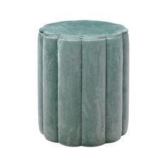 a small round stool made out of green velvet