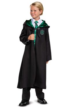 a young boy dressed in a harry potter robe and holding a sly wand with both hands