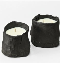 two black candles sitting next to each other