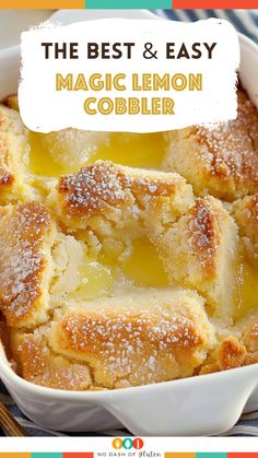 the best and easy magic lemon cobbler in a white dish with powdered sugar on top