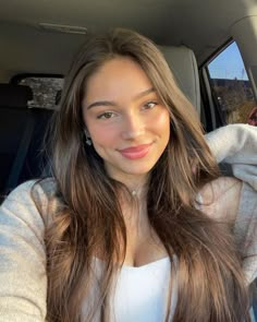 a woman sitting in the back seat of a car