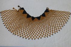 AKUJI African Beaded cape necklace made using 100% fine beads.

Color: Gold and Black

Closure: hook

Length: 16 inches long

Material: Beads

It is made on order hence it's ready to ship within 1-3 days.

Shipping cost is calculated during checkout.

DHL Express shipping that takes  3-5 days to be delivered Bohemian Beaded Evening Necklaces, Evening Beaded Bib Necklaces, Handmade Bohemian Necklaces For Evening, Handmade Bohemian Evening Necklaces, Handmade Necklaces With Round Beads For Evening, Bohemian Beaded Necklaces For Evening, Handmade Bohemian Evening Necklace, Handmade Evening Necklace With Round Beads, Elegant Bib Necklace With Large Beads