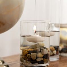 a candle that is sitting in some rocks