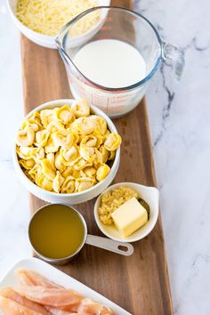 ingredients to make macaroni and cheese sitting on a cutting board