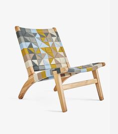 a wooden chair with a multicolored seat cover on it's back legs