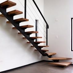 a wooden stair case with metal handrails