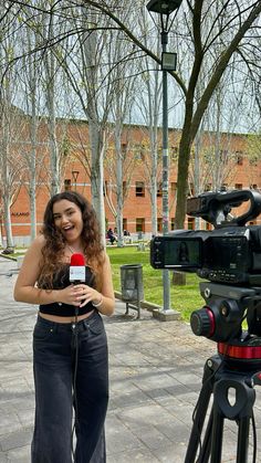 a woman standing in front of a camera