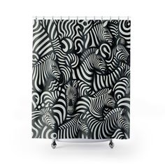 a black and white shower curtain with zebras in the middle, on top of wheels