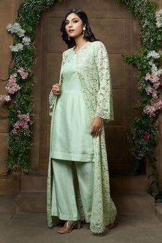 Pista green full sleeve jacket with floral lace and cutdana embroidery. Paired with solid sleeveless kurta and flared pant.
Components: 3
Pattern: Embroidery
Type Of Work: Floral, lace, cutdana
Neckline: Round
Sleeve Type: Cape: Bell sleeves, Kurta: Sleeveless
Fabric: Kurta and Pant: Bamberg Silk, Jacket: Santleen Net
Color: Green
Other Details: 
Scallop embroidered lace hem
Occasion: Destination Wedding - Aza Fashions Elegant Front-open Kurta With Zari Work, Elegant Front Open Kurta With Zari Work, Elegant Front Open Palazzo Set For Eid, Wedding Outerwear With Dupatta For Eid, Traditional Long Sleeve Palazzo Set For Formal Occasions, Traditional Long Sleeve Palazzo Set For Formal Events, Elegant Designer Nehru Jacket With Dupatta, Elegant Nehru Jacket With Dupatta For Designer Wear, Elegant Embroidered Front Open Kurta