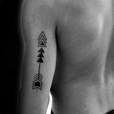 a black and white photo of a man's back with arrows on his left arm