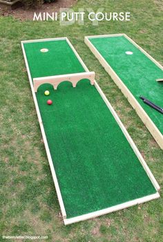 the mini golf course is set up on the grass with two pieces of equipment next to it