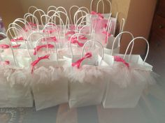 small bags with pink and white decorations on them