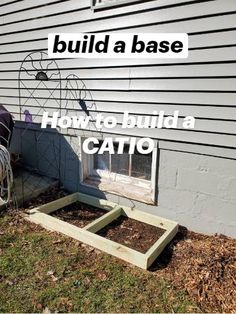 the back side of a house with an open window and planter box in it