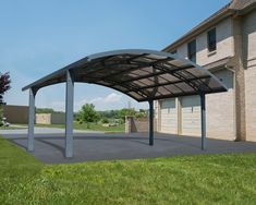 a large metal carport in front of a brick building