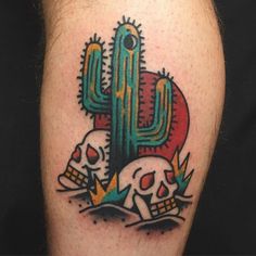 a skull and cactus tattoo on the leg