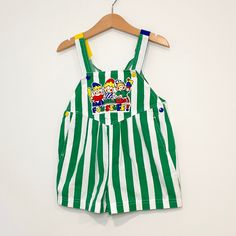 Green and white striped shortalls with blue and yellow straps & back pockets. Appliqué of three blonde white children with text “Fun Stuff!” on front. Good vintage condition with some expected wear. Size 3 (19” length). Fun Texts, Blue And Yellow, Age 3, Green And White, Fun Stuff, Vintage House, White Stripe, Overalls, Rompers