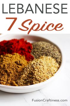 a bowl filled with different types of spices on top of a white counter next to an orange and red pepper