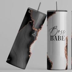 two stainless steel tumblers with black marble and rose gold foil on the sides, one is