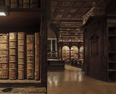 an old library filled with lots of books on top of wooden shelves next to each other