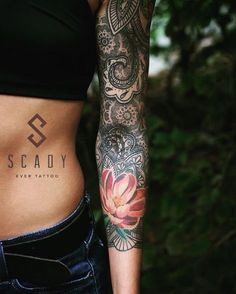 a woman's stomach with tattoos on it and the words scadly tattooed on her side