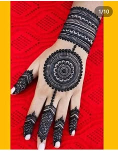 henna tattoo on the palm of a woman's hand with black and white designs