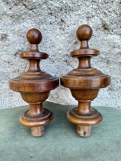 two wooden candlesticks sitting next to each other