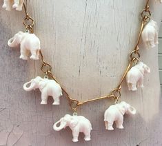 Whimsical fun statement vintage long elephant charm necklace.  Gold tone metal.  Pendant possibly resin/acrylic, unsure of exact composition.  Spring ring closure.  Boho, bohemian, cool unique jewelry. Approximate size 42 inches maximum length each elephant 0.75 inches tall and 1 1/8 inches wide Vintage, some dirt marks/scuffs on the elephants from age.  Needs further cleaning.  Sold as found. Props not included. Elephant Charm Necklace, Kurti Embroidery, Elephant Jewelry, Embroidery On Kurtis, Dangle Necklace, Resin Acrylic, Vintage Elephant, Elephant Bracelet, Dangle Necklaces