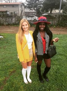 two women standing next to each other in the grass