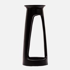 a black vase sitting on top of a white table