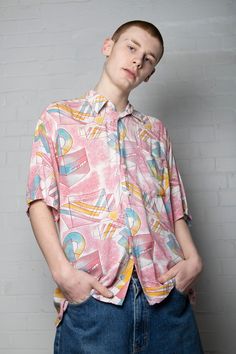 Ready yourselves for this jazzy vintage shirt featuring retro geometric shapes printed all over. This is the kind of geometry we can get behind! Comes in pastel pink to contrast the blue/yellow shape pattern. This is an iconic rare 70s/80s piece that is sure to turn heads. Comes in a relaxed fit and white button down front and collar as well as a nifty front pocket. Near perfect vintage condition- tiny bits of loose threading. No care label but feels like cotton material Width 46" Length 31" XL Pink Retro Shirt With Relaxed Fit, Retro Shirt With Colorful Pattern For Summer, Retro Summer Shirt With Colorful Pattern, Patterned Retro Print Shirt For Spring, Spring Patterned Shirt With Retro Print, Spring Retro Print Patterned Shirt, Retro Pink Top With Retro Print, Retro Patterned Shirt For Spring, Retro Pink Printed Shirt