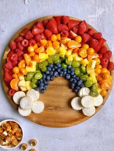 a wooden plate topped with fruits and vegetables