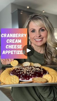 a woman holding up a sign that says cranberry cream cheese appetizer