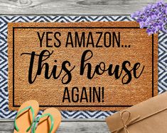 a door mat that says yes amazon this house again with sandals and flowers on it